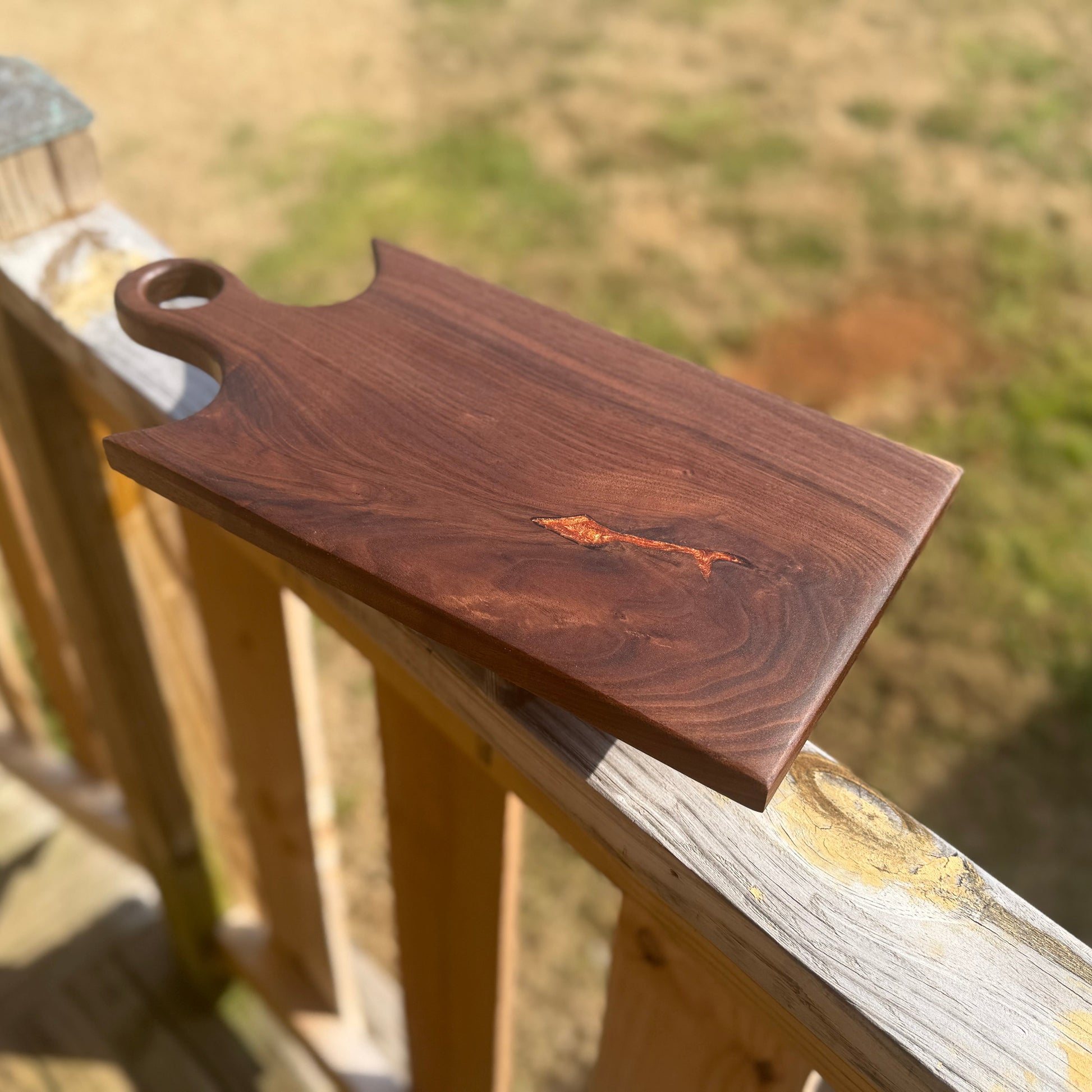 Walnut cutting board with a ring handle.