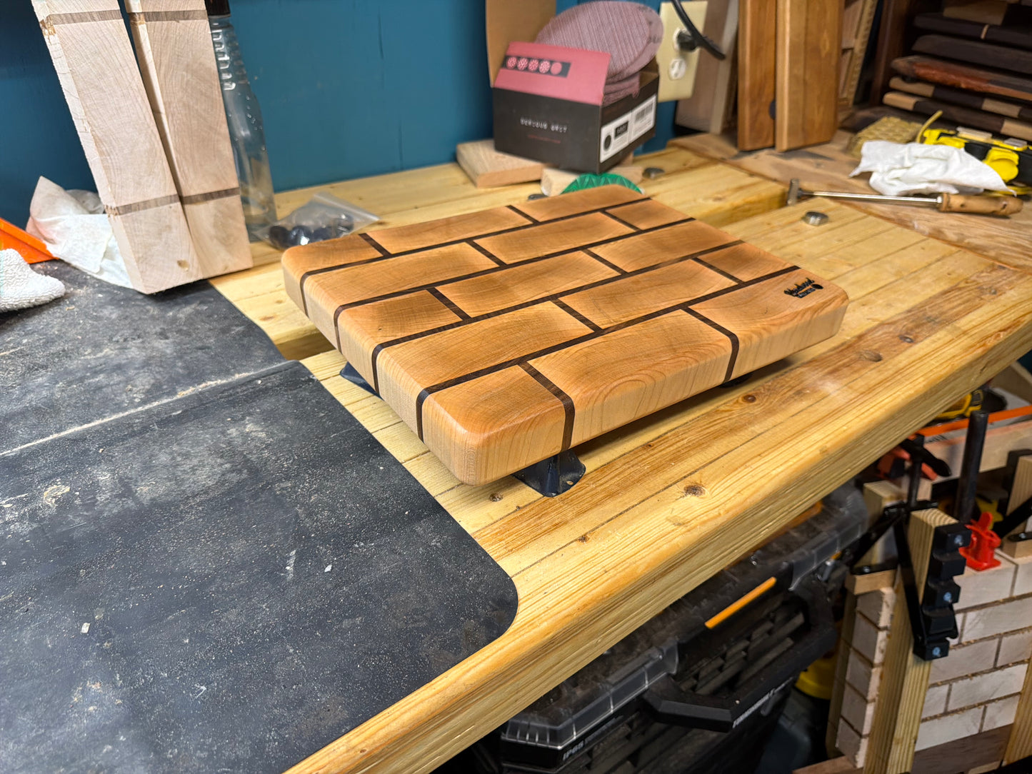 Maple end grain cutting board with walnut brick pattern, close-up front view